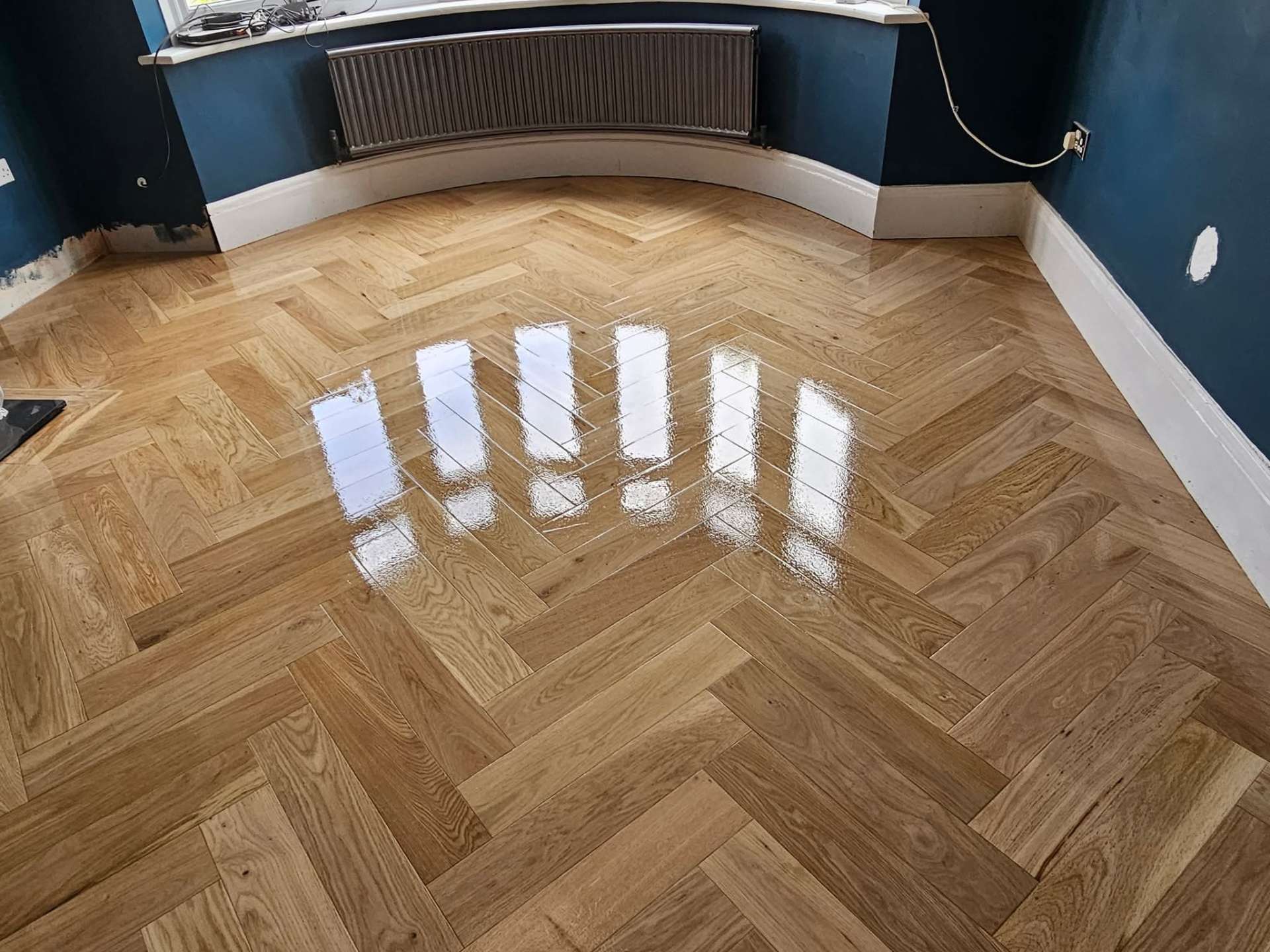 Herringbone parquet floor polished with high gloss lacquer finish